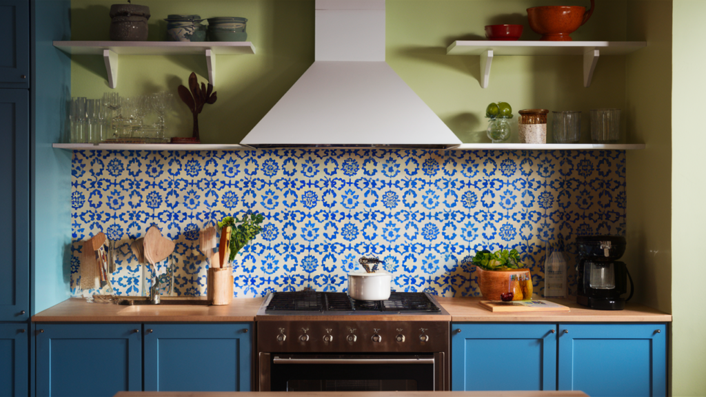 A bold patterned backsplash with blue and white