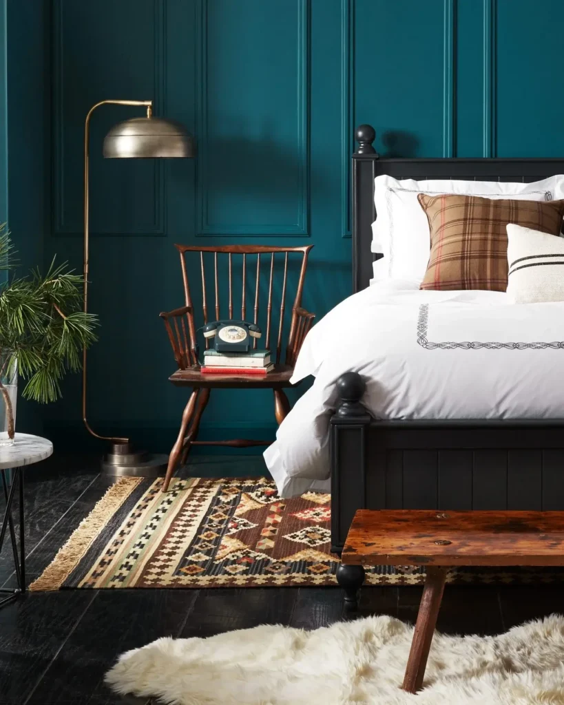 A Bedroom With A Dark Blue And Earthy Toned Design