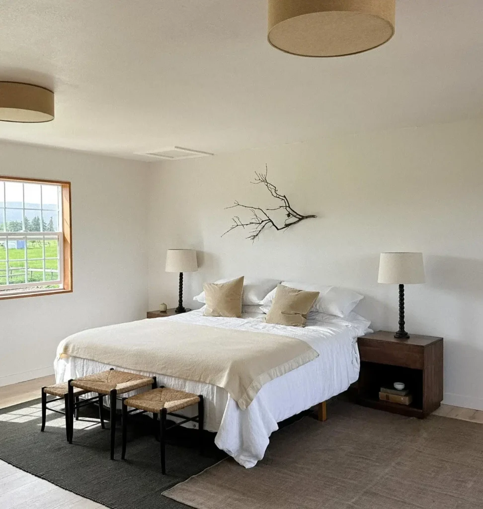 A Bedroom With Layered Textiles And Warm Beige Tones