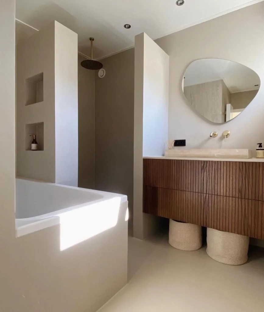 Bathroom With A Small Freestanding Tub And Natural Light