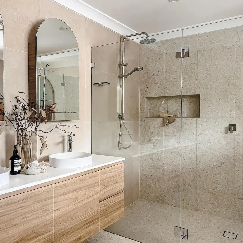 Elegant Beige-toned Bathroom With Arch Mirror