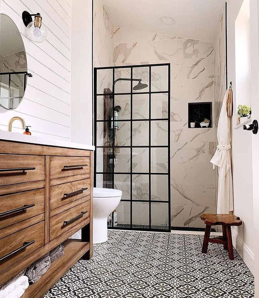 Elegant Powder Room With Round Mirror And Gold Fixtures