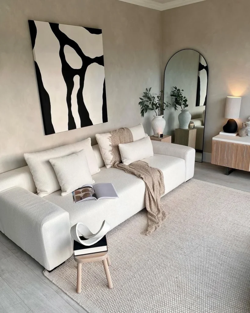 Elegant Living Room With A Chic Glass Coffee Table And Neutral Decor